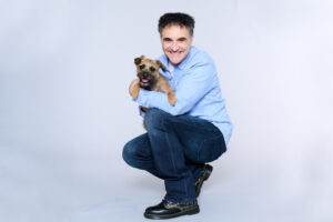 Supervet Noel Fitzpatrick holding a Border Terrier dog