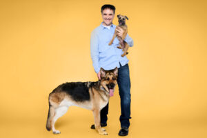 Supervet Noel Fitzpatrick with a Border Terrier and German Shepherd